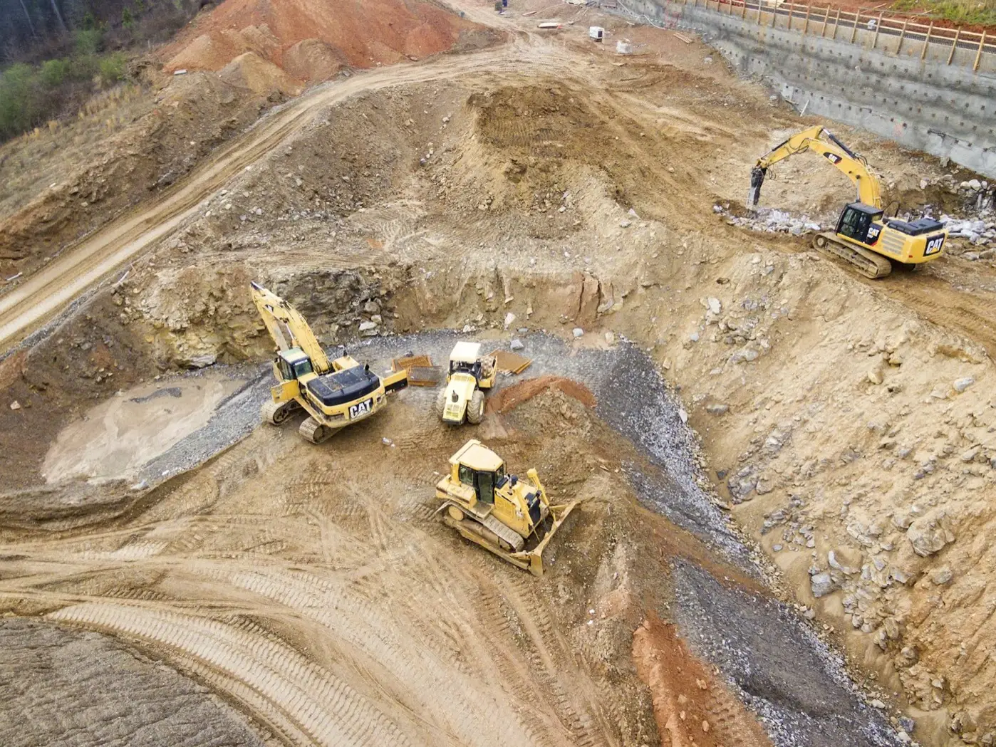 Excavators and a dozer working a quarry pit
